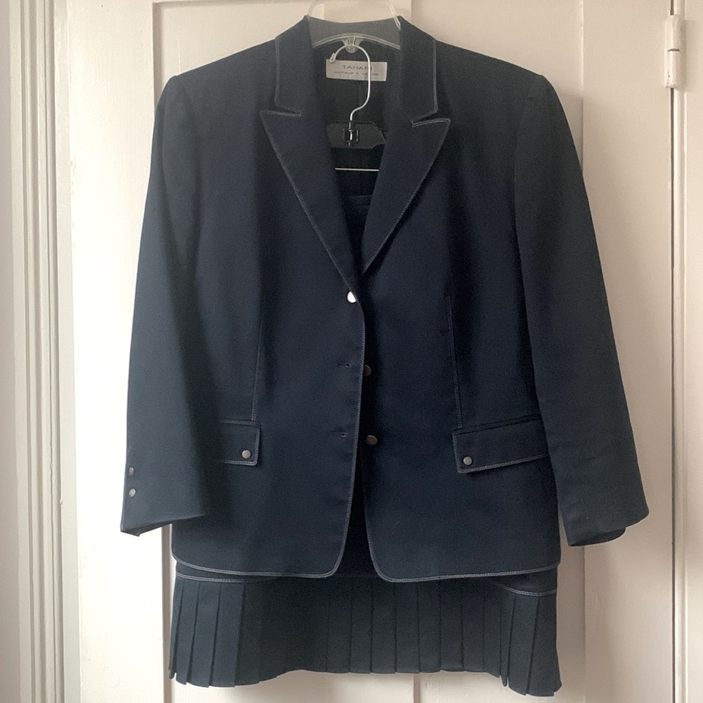 Tahari blue skirt suit with logo button details and pleated hem skirt. Size 10.